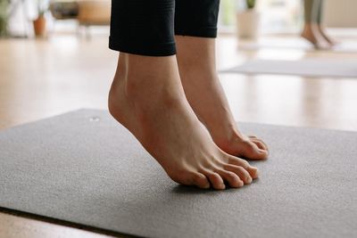Close-up of a person's feet on a yoga mat.